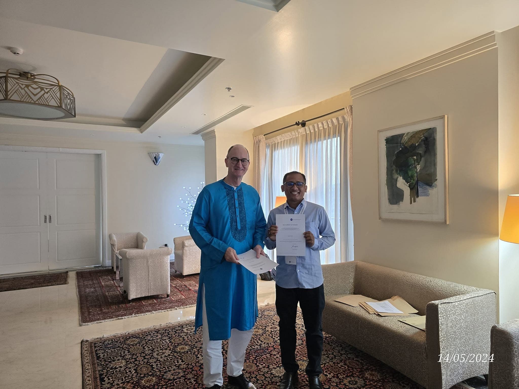 Uachash Barua receiving a DAAD document of award in May 2024
